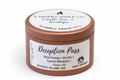 Deception Pass scented candle in copper tin labeled blood orange, dry gin, cypress mandarin, clove, and fir.