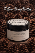 Lemongrass tallow body butter in dark jar on pinecone background